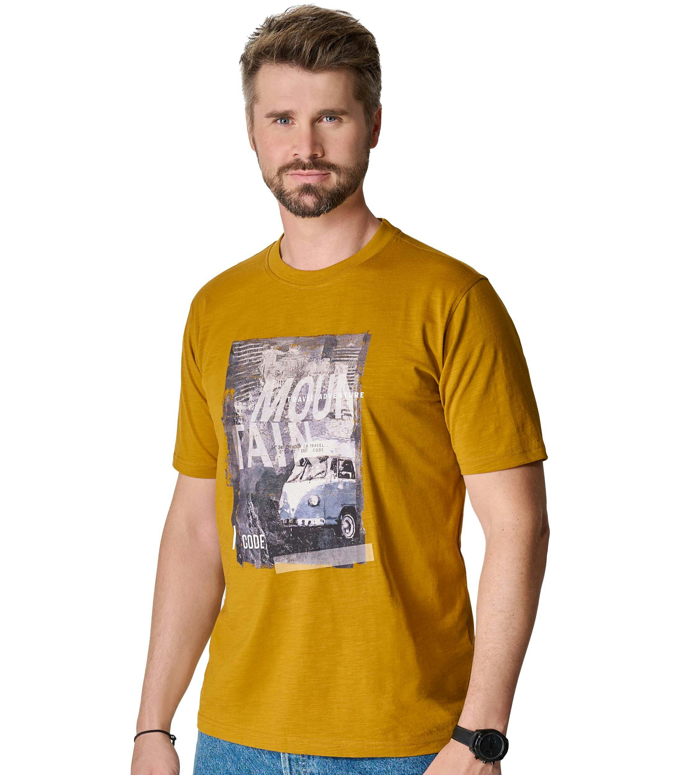 Das Model trägt ein TShirt im uni Muster in der Farbe Senfgelb