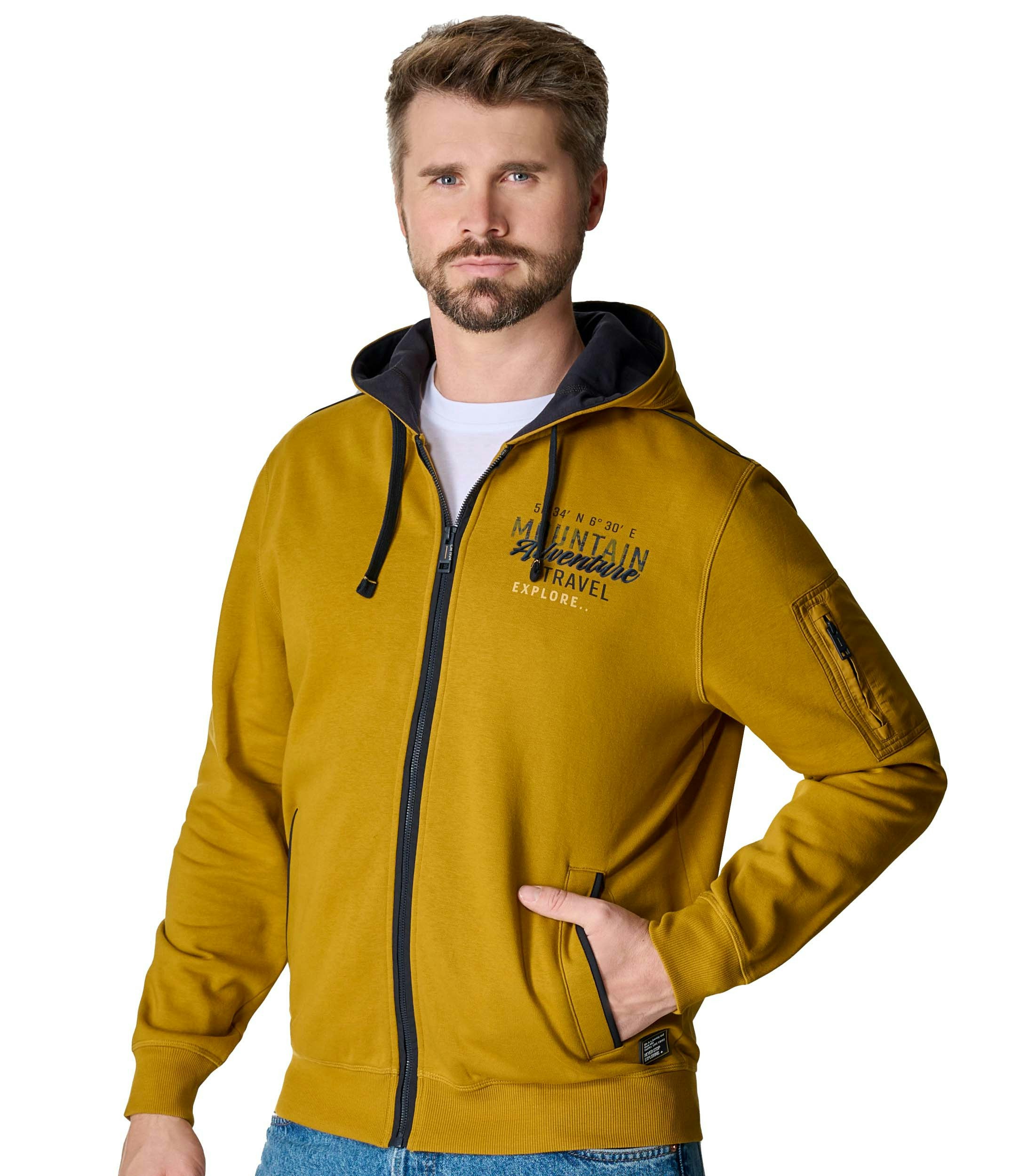 Das Model trägt ein Sweatshirt im uni Muster in der Farbe Senfgelb
