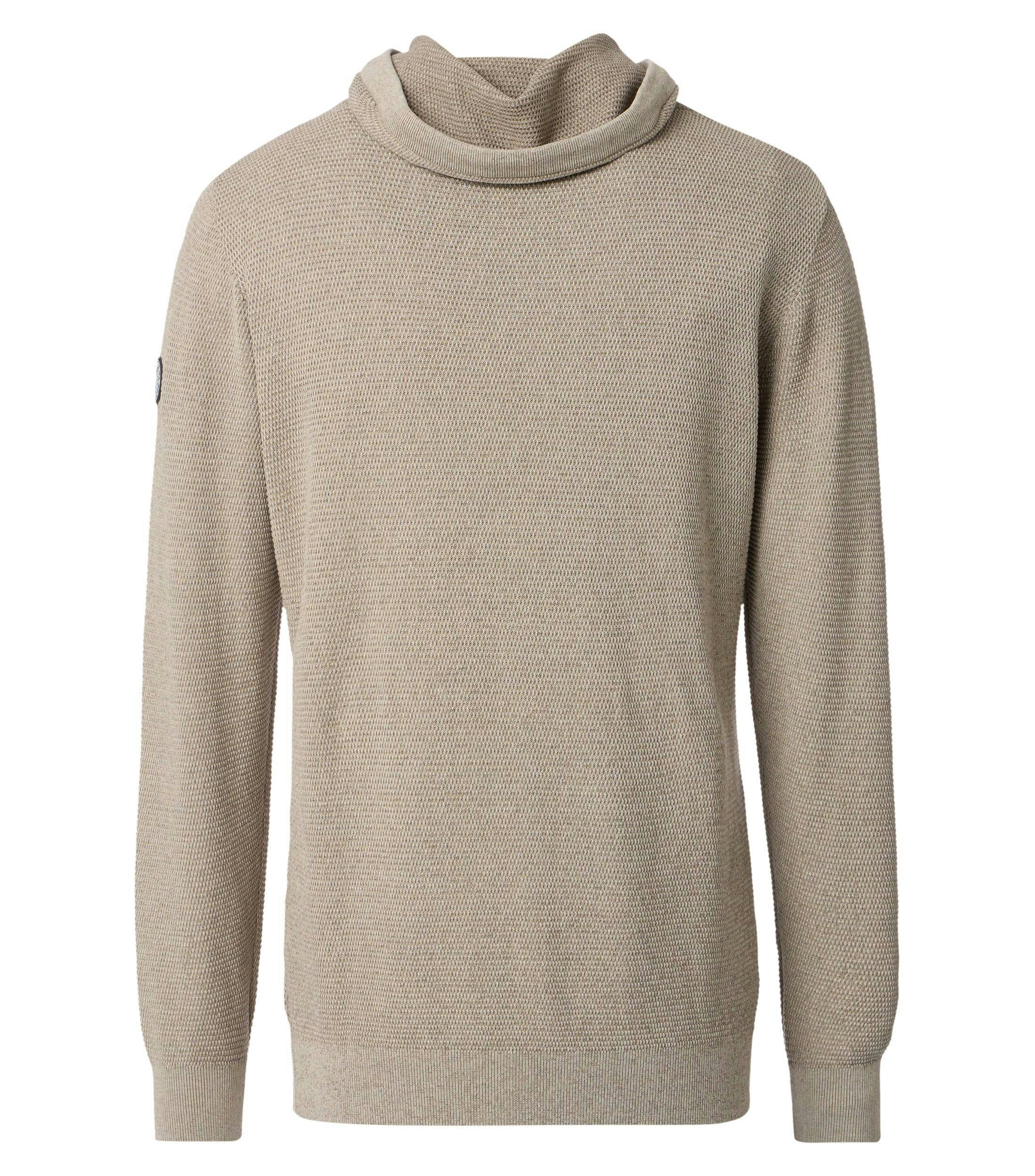 Das Model trägt ein Pullover im uni Muster in der Farbe Beige