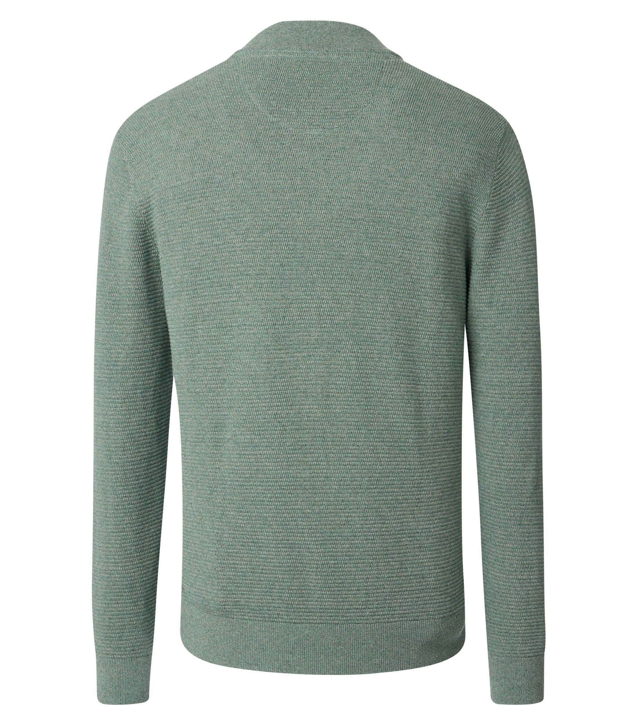 Das Model trägt eine Strickjacke im uni Muster in der Farbe Mint