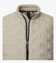 Das Model trägt eine Weste im uni Muster in der Farbe Weißbeige