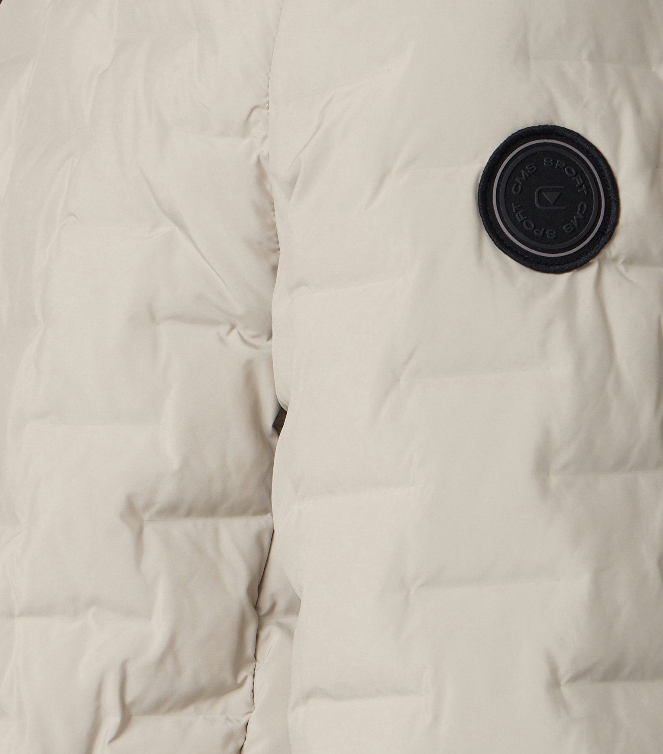 Das Model trägt eine Jacke im uni Muster in der Farbe Weißbeige