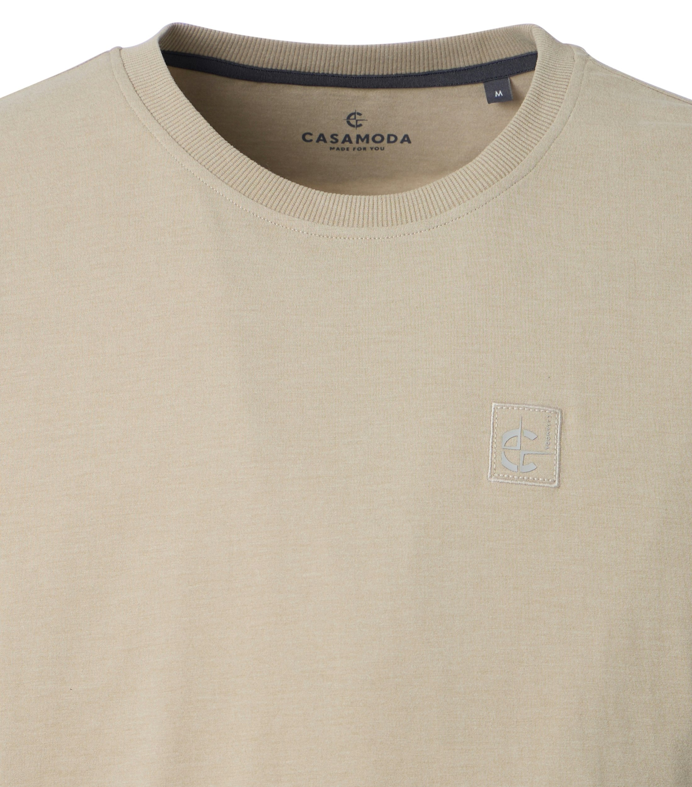 Ein T-Shirt im uni Muster in der Farbe Beige