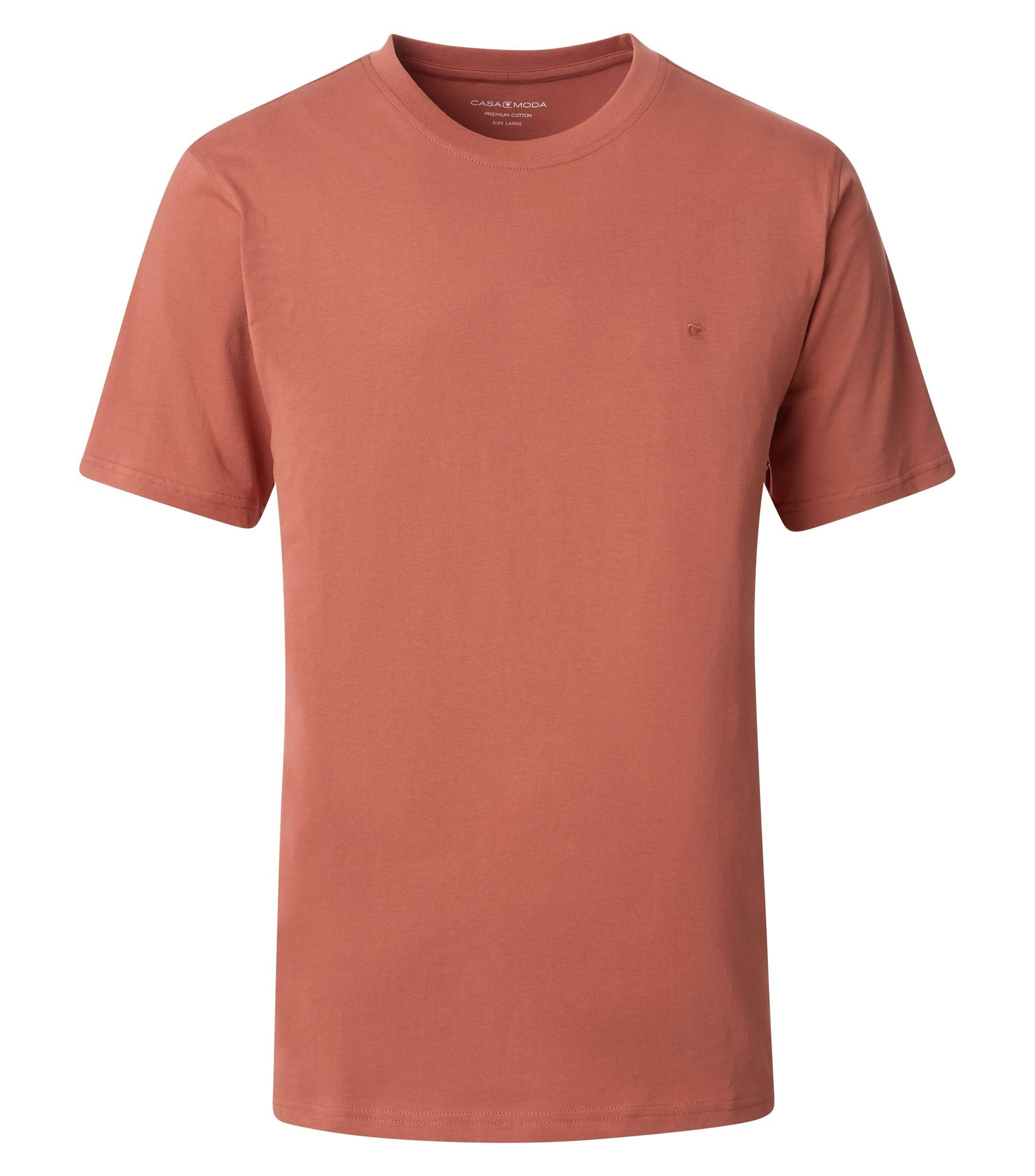 Das Model trägt ein TShirt im uni Muster in der Farbe Hellorange