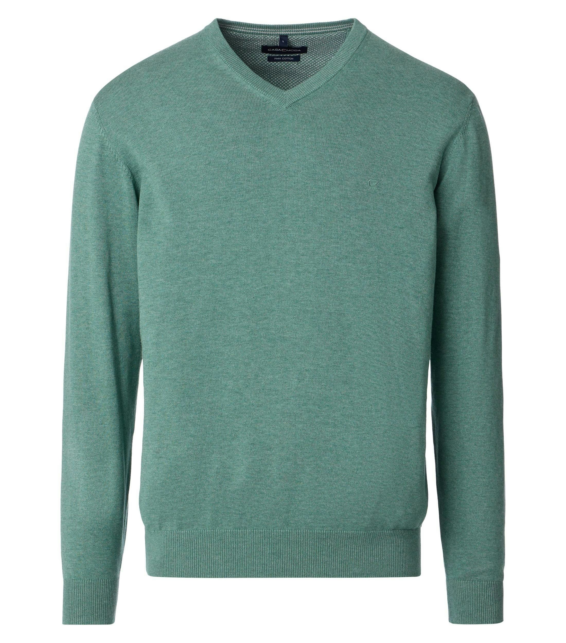 Das Model trägt ein Pullover im uni Muster in der Farbe  Türkisgrün