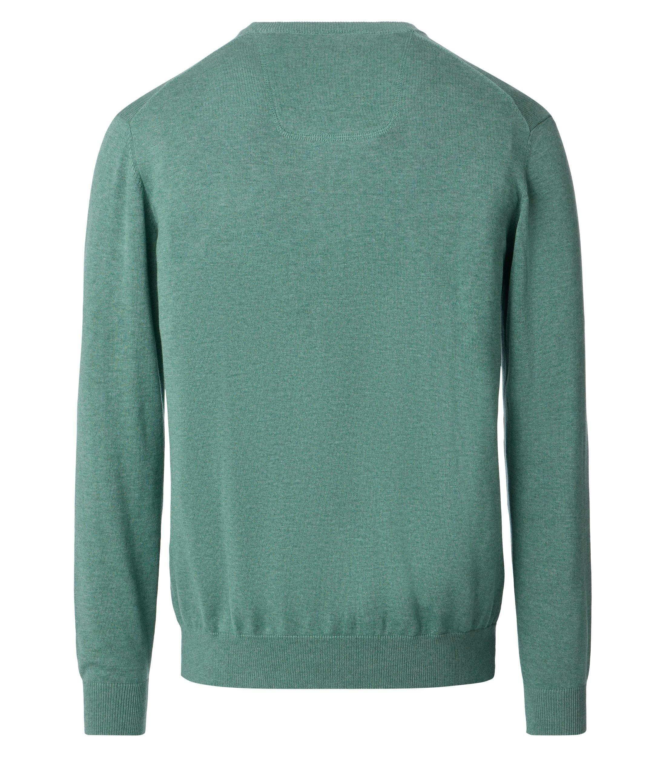 Das Model trägt ein Pullover im uni Muster in der Farbe  Türkisgrün