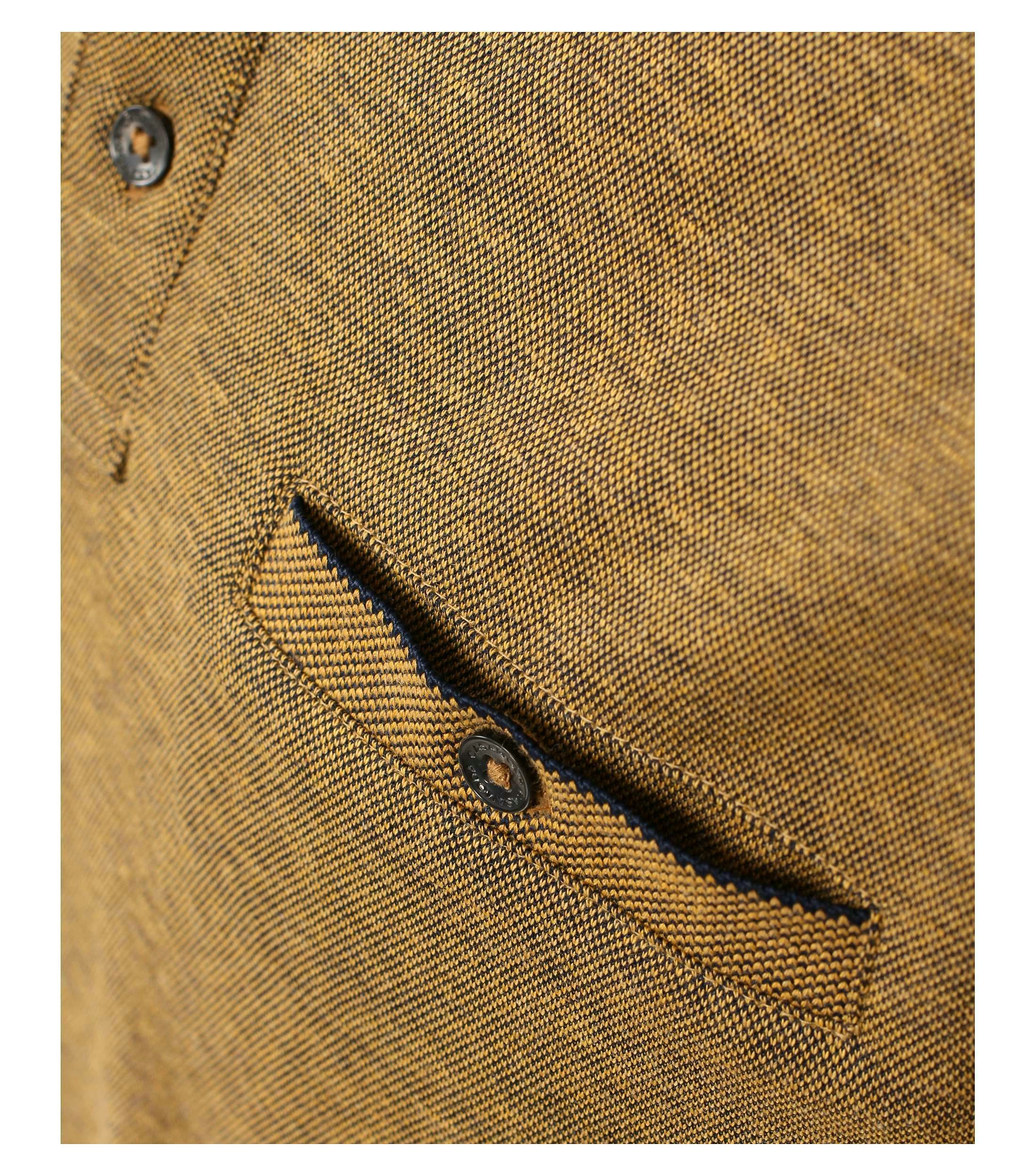 Das Model trägt ein PoloShirt im gestreift Muster in der Farbe Senfgelb