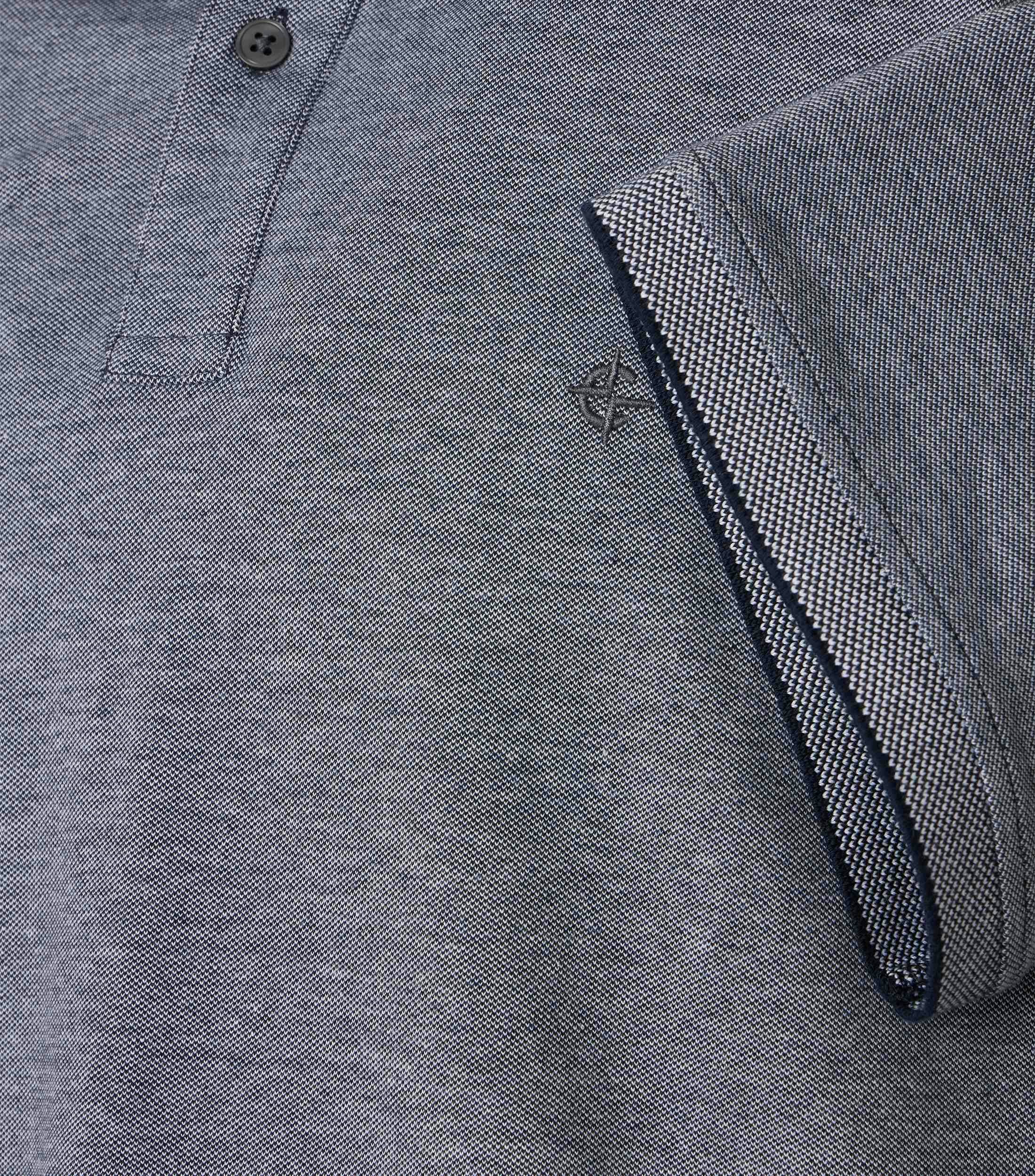 Das Model trägt ein PoloShirt im uni Muster in der Farbe Weißblau