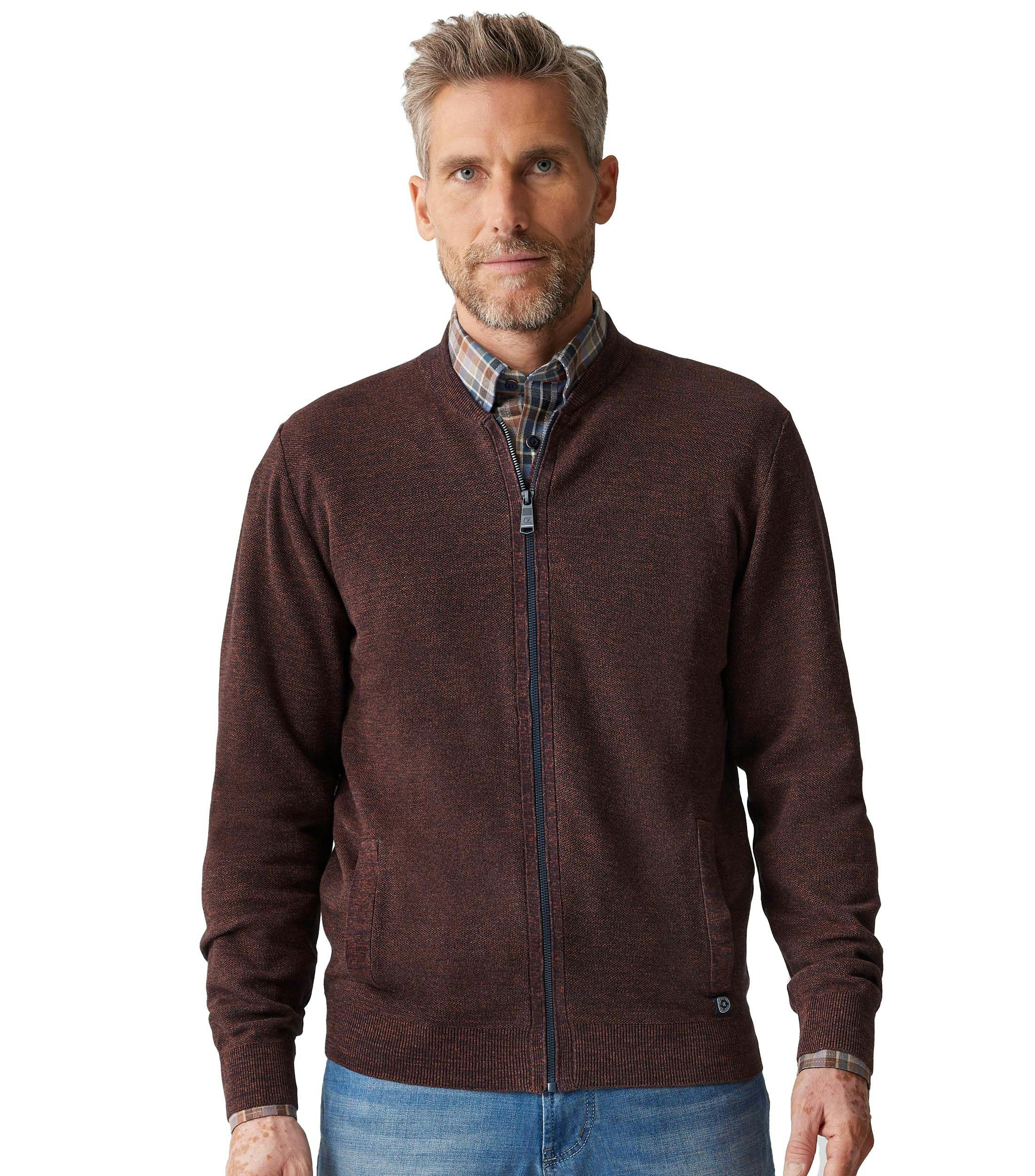 Das Model trägt eine Strickjacke im uni Muster in der Farbe Dunkelorange